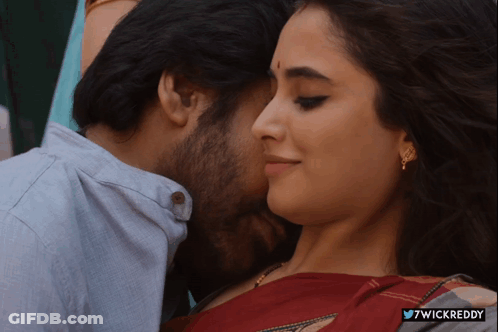 A Close Up Of A Man Kissing A Woman With The Hashtag 7Wickreddy On The Bottom GIF