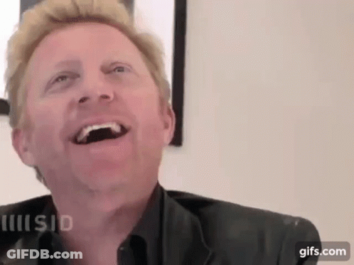 A Close Up Of A Man Laughing With His Mouth Open And His Eyes Closed . GIF