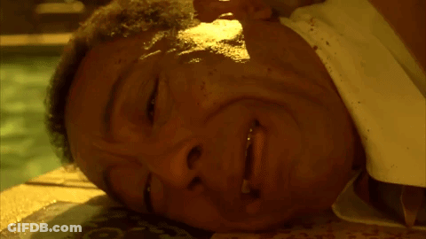 A Close Up Of A Man Laying On The Ground With His Eyes Closed GIF