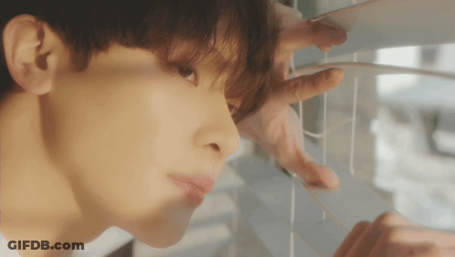 A Close Up Of A Man Looking Out A Window GIF