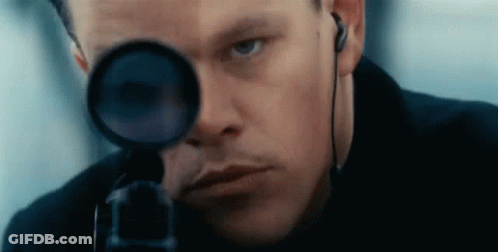 A Close Up Of A Man Looking Through A Scope . GIF