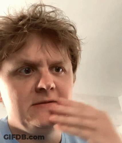 A Close Up Of A Man Making A Face With His Hand GIF