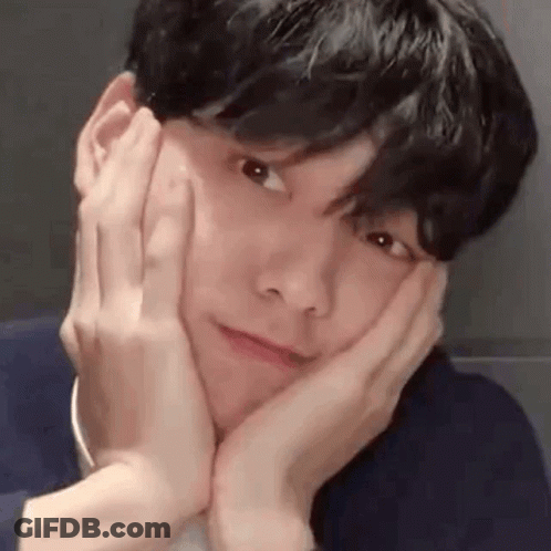 A Close Up Of A Man Making A Face With His Hands On His Face . GIF