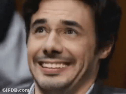 A Close Up Of A Man Making A Funny Face While Smiling . GIF