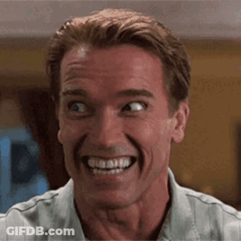 A Close Up Of A Man Making A Funny Face While Smiling . GIF