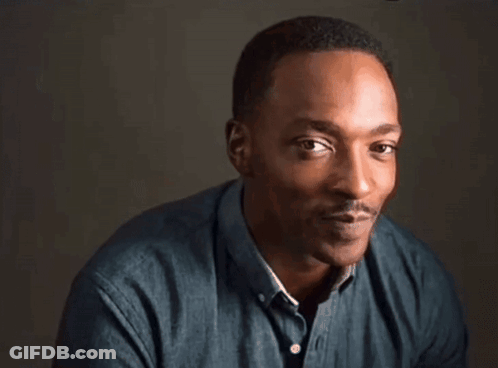A Close Up Of A Man Making A Funny Face While Wearing A Blue Shirt . GIF