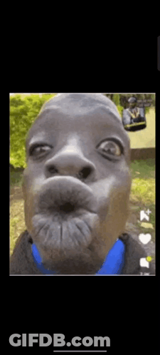 A Close Up Of A Man Making A Funny Face With A Blue Shirt . GIF