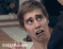 A Close Up Of A Man Making A Funny Face With His Mouth Open GIF