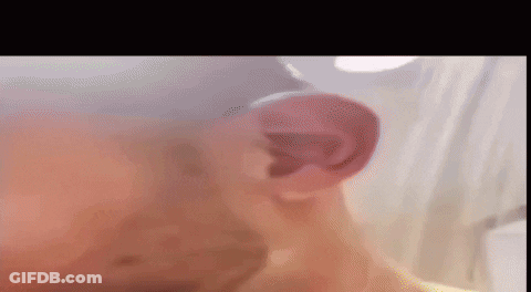 A Close Up Of A Man 'S Ear With A Blurred Background . GIF
