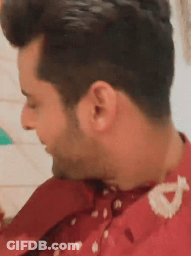 A Close Up Of A Man 'S Ear With A Red Shirt On . GIF