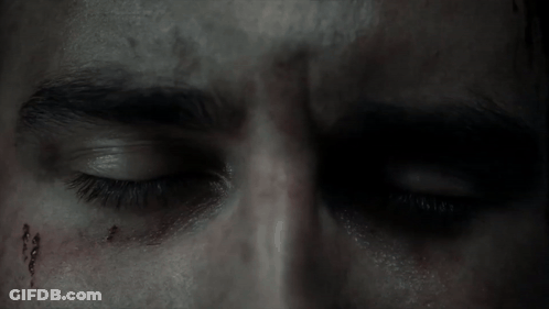 A Close Up Of A Man 'S Eye With Blood On His Forehead GIF