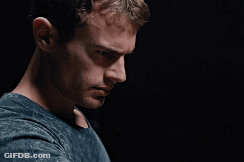 A Close Up Of A Man 'S Face Against A Black Background GIF