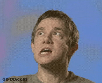 A Close Up Of A Man 'S Face Against A Blue Background GIF