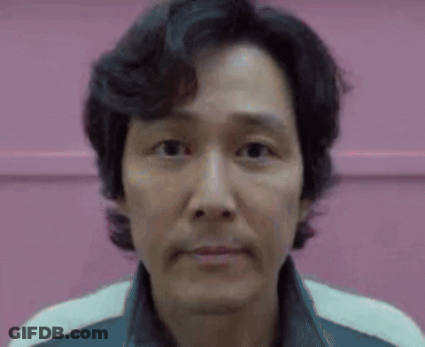 A Close Up Of A Man 'S Face Against A Pink Background . GIF