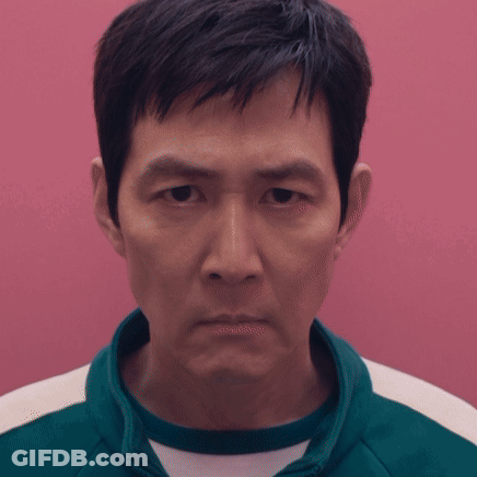 A Close Up Of A Man 'S Face Against A Pink Wall GIF