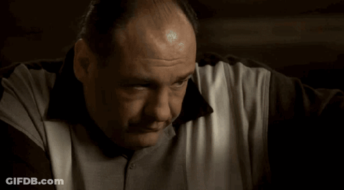 A Close Up Of A Man 'S Face And Arm With A Bandage On His Wrist . GIF