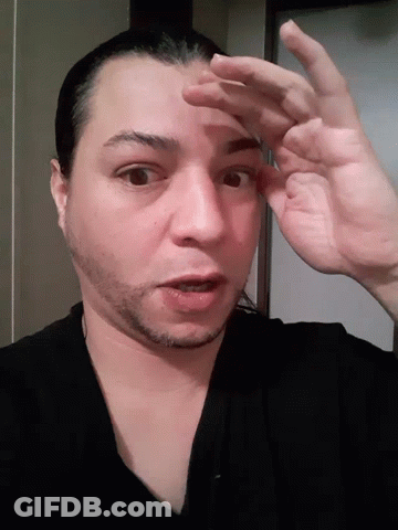 A Close Up Of A Man 'S Face And Hands GIF