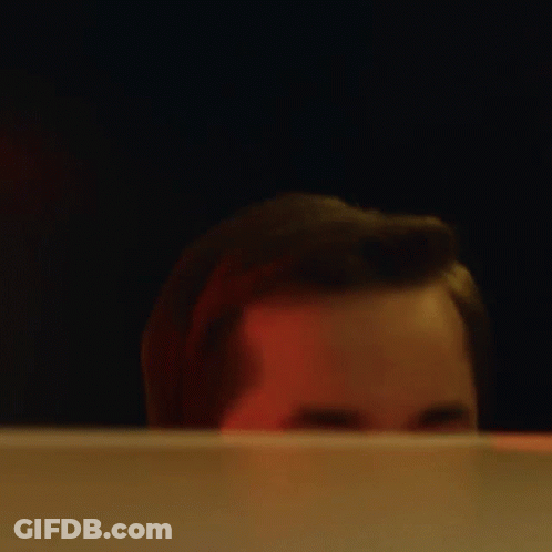 A Close Up Of A Man 'S Face Behind A Screen GIF