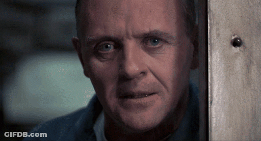 A Close Up Of A Man 'S Face Behind A Wall GIF