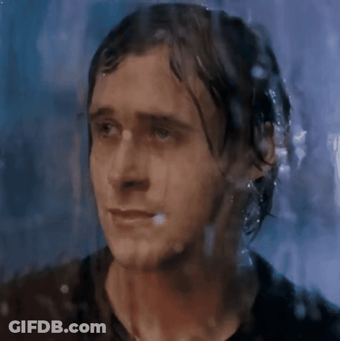 A Close Up Of A Man 'S Face Behind A Wet Glass GIF