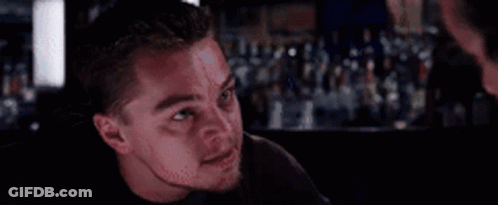 A Close Up Of A Man 'S Face In A Bar . GIF