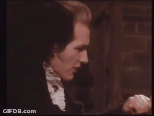 A Close Up Of A Man 'S Face In A Black And White Image GIF