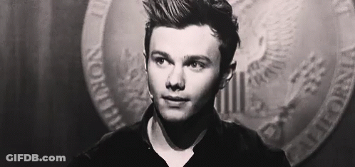 A Close Up Of A Man 'S Face In A Black And White Photo With A Coin In The Background . GIF