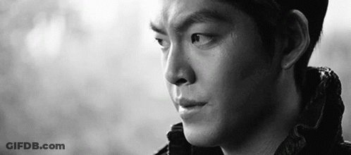 A Close Up Of A Man 'S Face In A Black And White Photo With A Serious Look On His Face . GIF