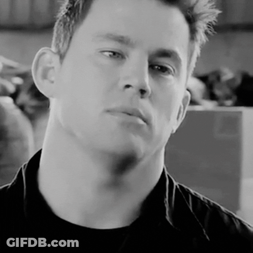 A Close Up Of A Man 'S Face In A Black Shirt GIF