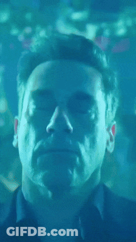 A Close Up Of A Man 'S Face In A Blue Light GIF