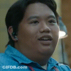 A Close Up Of A Man 'S Face In A Blue Shirt GIF