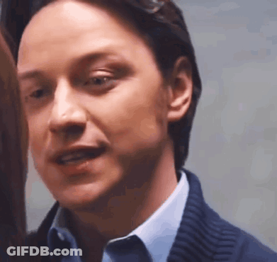 A Close Up Of A Man 'S Face In A Blue Shirt And Blue Sweater . GIF
