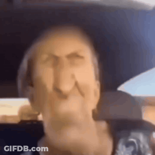 A Close Up Of A Man 'S Face In A Car . GIF