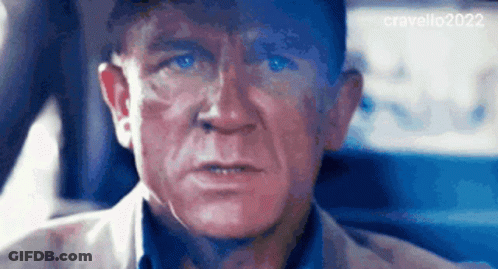 A Close Up Of A Man 'S Face In A Car With A Blue Background GIF
