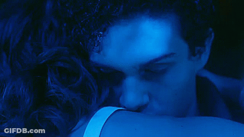A Close Up Of A Man 'S Face In A Dark Blue Light GIF