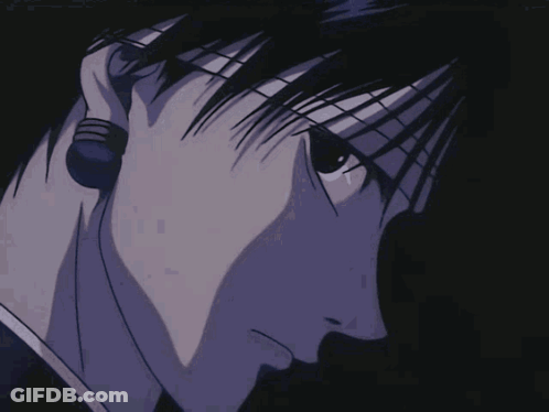 A Close Up Of A Man 'S Face In A Dark Room GIF