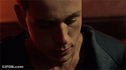 A Close Up Of A Man 'S Face In A Dark Room . GIF