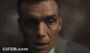 A Close Up Of A Man 'S Face In A Dark Room . GIF