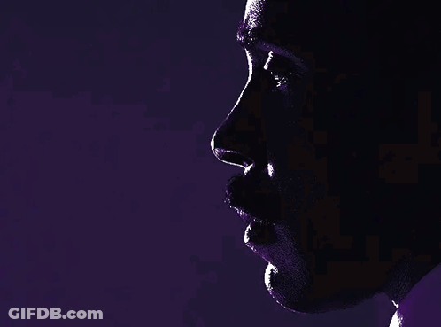 A Close Up Of A Man 'S Face In A Dark Room GIF