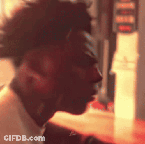 A Close Up Of A Man 'S Face In A Dark Room . GIF