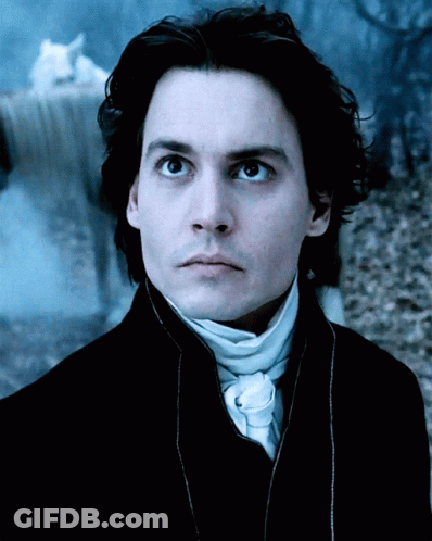 A Close Up Of A Man 'S Face In A Dark Room GIF