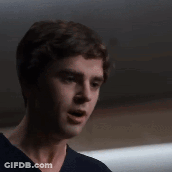 A Close Up Of A Man 'S Face In A Dark Room . GIF