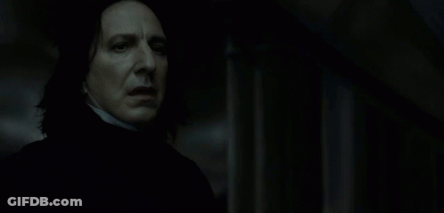A Close Up Of A Man 'S Face In A Dark Room . GIF