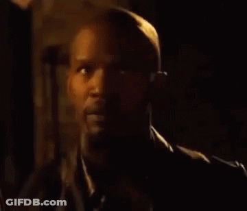 A Close Up Of A Man 'S Face In A Dark Room . GIF