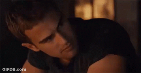 A Close Up Of A Man 'S Face In A Dark Room Looking At The Camera . GIF
