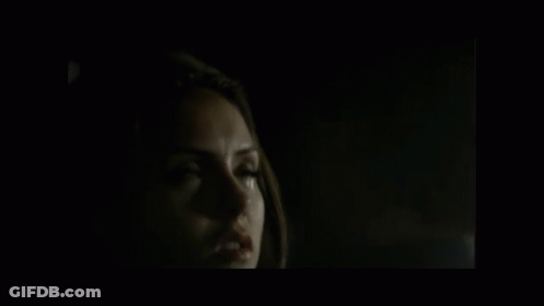 A Close Up Of A Man 'S Face In A Dark Room . GIF