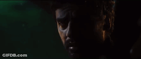 A Close Up Of A Man 'S Face In A Dark Room . GIF