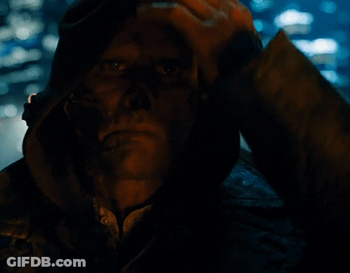 A Close Up Of A Man 'S Face In A Dark Room GIF