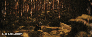 A Close Up Of A Man 'S Face In A Dark Room With A Backpack . GIF
