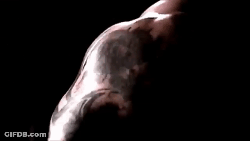 A Close Up Of A Man 'S Face In A Dark Room With A Black Background . GIF